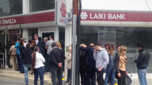 Cypriots line up at the ATM to withdraw their savings in the midst of the banking crisis in Nicosia, Cyprus.